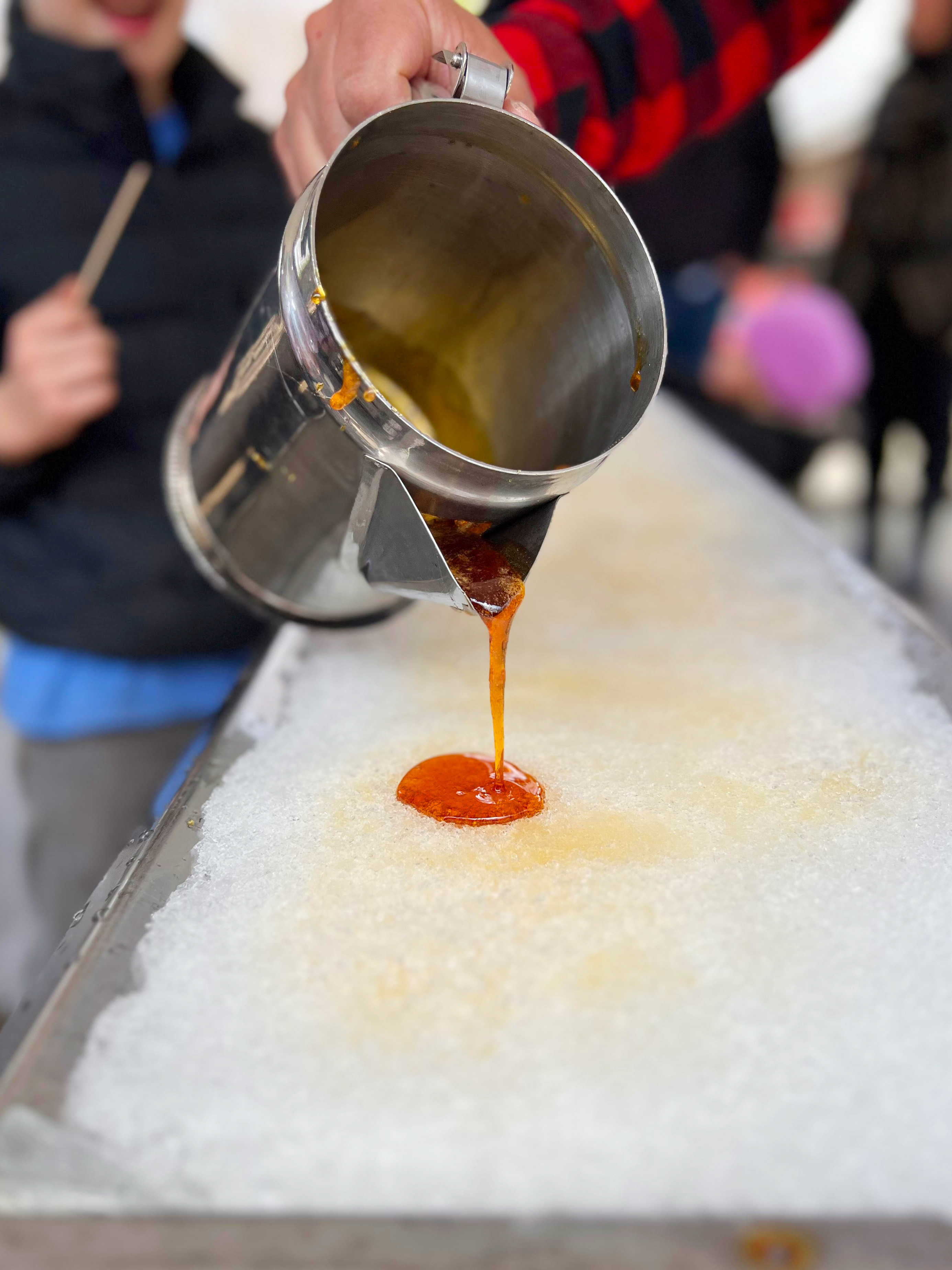 Pouring maple taffy on snow